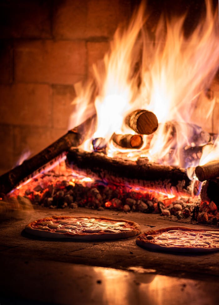 Crafting Captivating Headlines: Your awesome post title goes here Delicious pizzas cooking in a traditional wood-fired oven, radiating warmth and flavor.